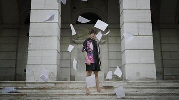 Blank sheets of paper fly around standing man video