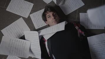 Sheets of paper fall in slow motion on the man's face video