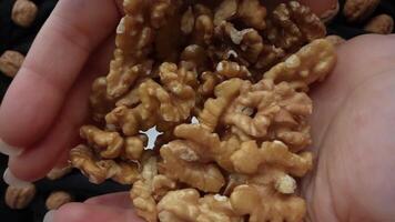 Shelled walnuts fall onto the plate video