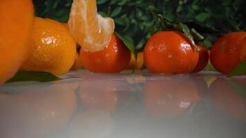 Slices of clementines fall in slow motion video