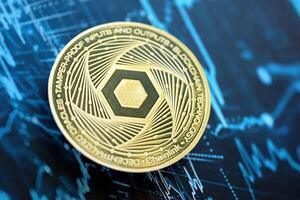 KYIV, UKRAINE - AUGUST 17, 2024 Chainlink LINK coin on abstract fictional cryptocurrency trading chart in blue color photo