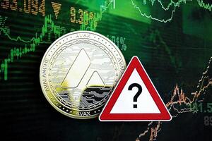 KYIV, UKRAINE - AUGUST 17, 2024 Avalanche AVAX coin and red paper question sign on chart background photo