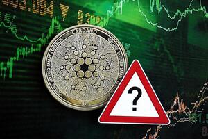 KYIV, UKRAINE - AUGUST 17, 2024 Cardano ADA coin and red paper question sign on chart background photo