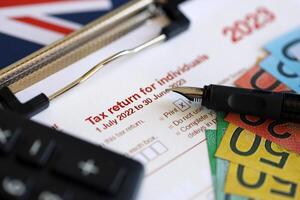 KYIV, UKRAINE - JULY 10, 2024 Australian Tax Return for individuals blank form lies on table of Australian Government taxation office photo
