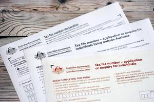 KYIV, UKRAINE - JULY 10, 2024 Australian Tax File Number Application or enquiry for individuals and declaration blank form lies on table of Australian Government taxation office photo