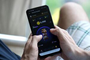 KYIV, UKRAINE - APRIL 20, 2024 Hamster Kombat telegram bot on smartphone screen. Hamster Kombat is a viral Telegram crypto game for earn HMSTR tokens by managing virtual crypto exchange photo