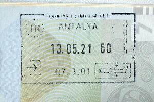 KYIV, UKRAINE - APRIL 20, 2024 Page of foreign passport with visas, Turkiye border stamps, permits to enter countries, concept of traveling around the world, travelers document photo