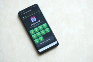 KYIV, UKRAINE - APRIL 20, 2024 Hamster Kombat telegram bot on smartphone screen. Hamster Kombat is a viral Telegram crypto game for earn HMSTR tokens by managing virtual crypto exchange photo