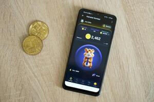 KYIV, UKRAINE - APRIL 20, 2024 Hamster Kombat telegram bot on smartphone screen. Hamster Kombat is a viral Telegram crypto game for earn HMSTR tokens by managing virtual crypto exchange photo