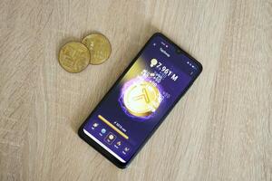 KYIV, UKRAINE - APRIL 20, 2024 Tap Swap telegram bot on smartphone screen. Tap Swap is a viral Telegram based crypto game for earn tokens by managing virtual crypto exchange photo