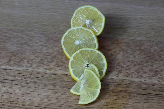 lemon slices neatly cut and lie on a wooden background. space for text photo