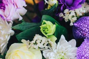 A bouquet of flowers in purple tones with a bud of eustoma and chrysanthemum. Close view photo