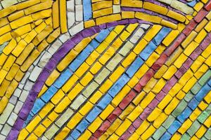 texture of multi-colored stones. Background from vintage mosaic on the wall. photo