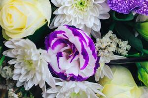 A bouquet of flowers in purple tones with a bud of eustoma and chrysanthemum. Close view photo