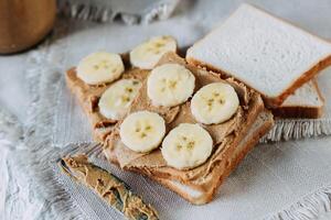 sandwich with peanut butter and bananas. Healthy and tasty breakfast or snack. photo