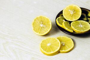 lemon slices neatly cut and lie on a wooden background. space for text photo