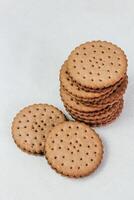 Crispy chocolate cinnamon with holes on a wooden board. Round biscuits with filling. space for text photo