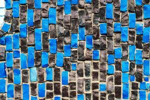 texture of multi-colored stones. Background from vintage mosaic on the wall. photo