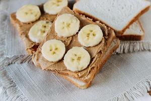 sandwich with peanut butter and bananas. Healthy and tasty breakfast or snack. photo