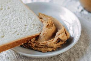 thick peanut butter in a jar close-up. Healthy eating photo