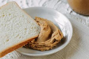 thick peanut butter in a jar close-up. Healthy eating photo