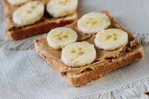sandwich with peanut butter and bananas. Healthy and tasty breakfast or snack. photo