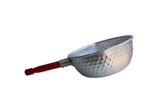 A silver pan with a wooden handle sits on a white background. The pan is empty and has a circular shape photo