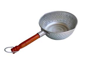 A silver pan with a wooden handle sits on a white background. The pan is empty and has a circular shape photo
