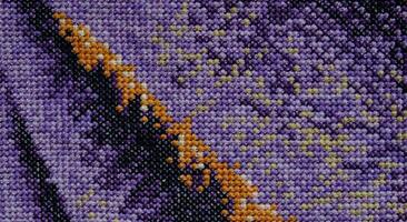 Purple, violet and brown close-up cross stitch background. Abstract Embroidered handmade Pattern. Needlework and DIY concept. Top view, macro, flat lay, mockup. photo