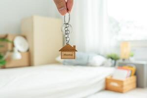 Moving house, relocation. The key was inserted into the door of the new house, inside the room was a cardboard box containing personal belongings and furniture. move in the apartment or condominium photo