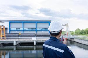 maintenance and inspector. Maintenance engineers are using walky talky to inform the results of inspection of buildings and structures. Irrigation engineers are exploring sluice systems photo
