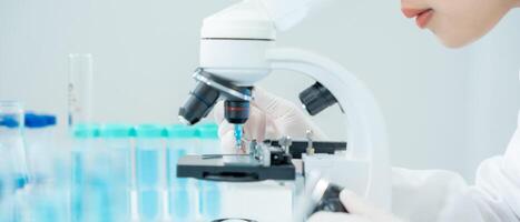 Scientist analyze biochemical samples in advanced scientific laboratory. Medical professional use microscope look microbiological developmental of viral. Biotechnology research in science lab. photo