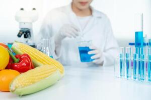 Scientist check chemical food residues in laboratory. Control experts inspect quality of vegetables vegetables. lab, hazards, find prohibited substances, contaminate, Microscope, Microbiologist photo