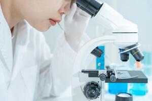Scientist analyze biochemical samples in advanced scientific laboratory. Medical professional use microscope look microbiological developmental of viral. Biotechnology research in science lab. photo