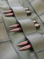 Pairs Of Ammunition Under Threaded Belts Of Unloading Vest Closeup Angle View photo