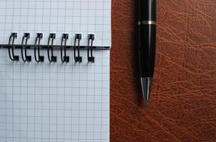 Binder Notepad With White Pages And Opened Pen On A Leather Folder Stock Photo For Title Or Business Logo