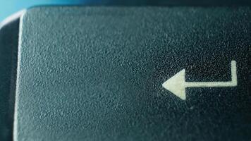 Close-Up of an Arrow Key on a Computer Keyboard Against a Soft Blue Background photo