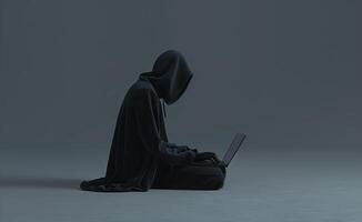 Mysterious Figure in Black Hoodie Using Laptop in Dark Environment photo