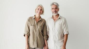 Middle-Aged Couple Smiling and Holding Hands in Casual Clothing photo