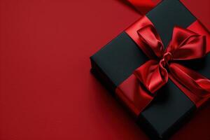 Luxurious Black Gift Box Adorned With Red Satin Ribbon on Red Background photo