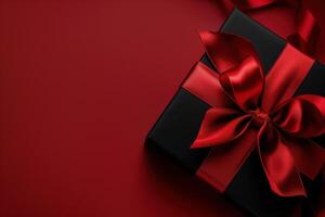 Luxurious Black Gift Box with Red Satin Ribbon on Red Background photo