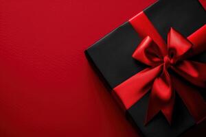 Luxurious Black Gift Box with Vibrant Red Ribbon, Perfect for Special Occasions photo