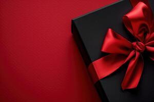 Luxurious Black Gift Box Adorned with Vibrant Red Ribbon on Elegant Red Background photo
