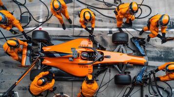 Formula One Pit Crew in Action High-Angle View of Car Maintenance photo