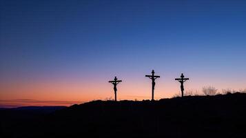 Silhouette of Three Crucifixes on Mount Calvary at Sunset photo