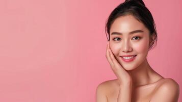 Beautiful Woman Embracing Skincare Routine with Radiant Smile on Soft Pink Background photo