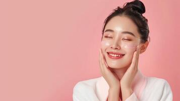 Beautiful Woman Enjoying Korean Beauty Skincare Routine with Moisturizing Cream on Pink Background photo