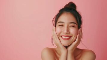 Radiant Young Woman Smiling with Relieved Expression in a Skincare and Beauty Concept on a Soft Pink Background photo