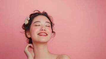Beautiful Woman Enjoying Skincare Routine with Radiant Smile on Pink Background photo
