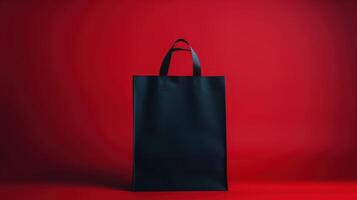 Elegant Black Tote Paper Bag Against a Bold Red Background Showcasing Modern Design and Practicality photo